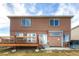 Back of a charming two-story house showcasing a spacious deck, sliding glass doors, and a well-maintained yard at 20341 E 48Th Pl, Denver, CO 80249