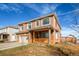 Two-story stucco house featuring a charming front porch and arched windows at 20341 E 48Th Pl, Denver, CO 80249