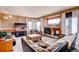 Cozy living room featuring a fireplace, comfortable seating, and a large TV at 20341 E 48Th Pl, Denver, CO 80249