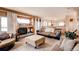 Inviting living room featuring a fireplace, comfortable seating, and seamless transition to the kitchen at 20341 E 48Th Pl, Denver, CO 80249