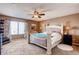 Spacious main bedroom featuring a ceiling fan, a large window and comfortable furniture at 20341 E 48Th Pl, Denver, CO 80249