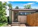 Back of home showcasing back door, brick patio, and fenced yard at 3319 Newton St, Denver, CO 80211