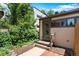 Back of home showcasing brick patio, steps, and fenced yard at 3319 Newton St, Denver, CO 80211