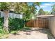 Backyard with planting beds, a wooden fence, and shade at 3319 Newton St, Denver, CO 80211