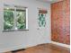 Cozy bedroom with original hardwood floors, exposed brick, and natural light at 3319 Newton St, Denver, CO 80211