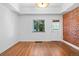 Spacious bedroom with wood floors, modern lighting and a door to the outside at 3319 Newton St, Denver, CO 80211
