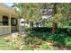 Landscaped front exterior with a covered porch, lush plantings and shade trees at 3319 Newton St, Denver, CO 80211