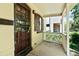 Cozy front porch with a decorative security door, classic railing, and shade from mature trees at 3319 Newton St, Denver, CO 80211