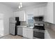 Kitchen area with modern appliances, ample storage, and tile flooring at 3319 Newton St, Denver, CO 80211