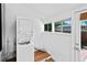 Cozy laundry room with stacked washer/dryer and natural light from backyard-facing windows at 3319 Newton St, Denver, CO 80211