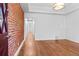Spacious living room with hardwood floors, white walls, and exposed brick detail at 3319 Newton St, Denver, CO 80211