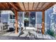 Covered backyard patio with grill, outdoor dining area, and sliding glass door access at 8489 S Quay St, Littleton, CO 80128