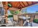 Backyard patio with wooden pergola and dining table, perfect for outdoor entertaining at 8489 S Quay St, Littleton, CO 80128