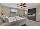 Bedroom with carpet floors, a ceiling fan, and a glimpse into the ensuite bathroom at 8489 S Quay St, Littleton, CO 80128