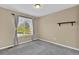 A view of the bedroom with natural light, carpet floors, and neutral walls at 8489 S Quay St, Littleton, CO 80128