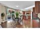 Dining area featuring hardwood floors, a dining table with four chairs, and access to the backyard at 8489 S Quay St, Littleton, CO 80128