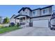 Charming two-story home with stone accents, a front porch, and a well-manicured lawn at 8489 S Quay St, Littleton, CO 80128