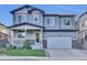 Lovely exterior view of a two-story home with blue trim, a covered front porch, and meticulous landscaping at 8489 S Quay St, Littleton, CO 80128