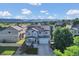 Exterior elevation of home with blue trim, solar panels, a well manicured lawn, and mountain views at 8489 S Quay St, Littleton, CO 80128