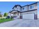 Inviting two-story home featuring a covered porch, a two car garage, and a well-manicured lawn at 8489 S Quay St, Littleton, CO 80128