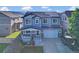 Beautiful two-story home with solar panels, covered porch, and well-kept lawn at 8489 S Quay St, Littleton, CO 80128