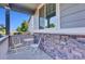 Cozy front porch with stone accents, seating, and great natural light at 8489 S Quay St, Littleton, CO 80128