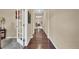 Hallway featuring hardwood floors, neutral walls, and a view into other rooms at 8489 S Quay St, Littleton, CO 80128