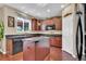 Features island, dark cabinets, black countertop and stainless steel appliances at 8489 S Quay St, Littleton, CO 80128