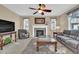 Inviting living room with a fireplace, ceiling fan, and a cozy seating area at 8489 S Quay St, Littleton, CO 80128
