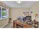 Well-lit office space with a large desk, multiple monitors, and a window at 8489 S Quay St, Littleton, CO 80128