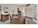 Spacious office featuring a large desk, a comfortable chair, and a view into another room at 8489 S Quay St, Littleton, CO 80128