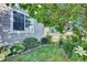 Small side yard with green grass and garden featuring a decorative owl birdhouse at 8489 S Quay St, Littleton, CO 80128