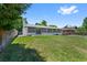 Spacious backyard with a well-maintained lawn and mature trees surrounding the property at 2646 S Pagosa Way, Aurora, CO 80013
