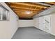 Unfinished basement with concrete floors, exposed beams, and a door leading to the upper levels at 2646 S Pagosa Way, Aurora, CO 80013