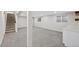 The basement featuring neutral carpeting and access to the stairs at 2646 S Pagosa Way, Aurora, CO 80013