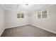 An empty basement bedroom featuring neutral carpeting and bright windows at 2646 S Pagosa Way, Aurora, CO 80013
