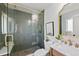 Elegant bathroom featuring a glass-enclosed shower, marble vanity, and stylish decor at 2646 S Pagosa Way, Aurora, CO 80013