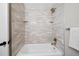 Clean bathroom showcasing a tub and shower combination with tiled walls and brushed fixtures at 2646 S Pagosa Way, Aurora, CO 80013