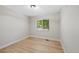 An empty bedroom with light wood floors and a bright window at 2646 S Pagosa Way, Aurora, CO 80013