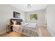 Calm bedroom with a patterned duvet, a modern light fixture, and a large window at 2646 S Pagosa Way, Aurora, CO 80013