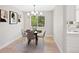 Cozy dining area featuring a round table, modern chandelier, and neutral wall decor at 2646 S Pagosa Way, Aurora, CO 80013