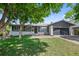 Well-maintained home with a lush front yard and a two-car garage, nestled under a mature shade tree at 2646 S Pagosa Way, Aurora, CO 80013