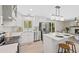 Bright kitchen with white cabinets, stainless steel appliances, and a center island at 2646 S Pagosa Way, Aurora, CO 80013