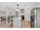 Modern kitchen featuring white cabinets, stainless steel appliances, and a center island with seating at 2646 S Pagosa Way, Aurora, CO 80013