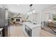 Open-concept kitchen island with stainless steel microwave and view of a fireplace at 2646 S Pagosa Way, Aurora, CO 80013