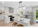 Modern kitchen featuring white cabinets, stainless steel appliances, and a center island with seating at 2646 S Pagosa Way, Aurora, CO 80013