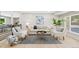Bright living room featuring neutral furniture, light wood floors, and a stylish area rug at 2646 S Pagosa Way, Aurora, CO 80013