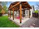 Backyard patio with wooden pergola and gravel features direct access to home and yard at 13313 Cherry Cir, Thornton, CO 80241