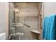 Walk-in shower features modern tile, glass door, shower seat, and built in shelf at 13313 Cherry Cir, Thornton, CO 80241