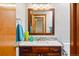 Bathroom features modern vanity, decorative mirror, and tiled backsplash at 13313 Cherry Cir, Thornton, CO 80241
